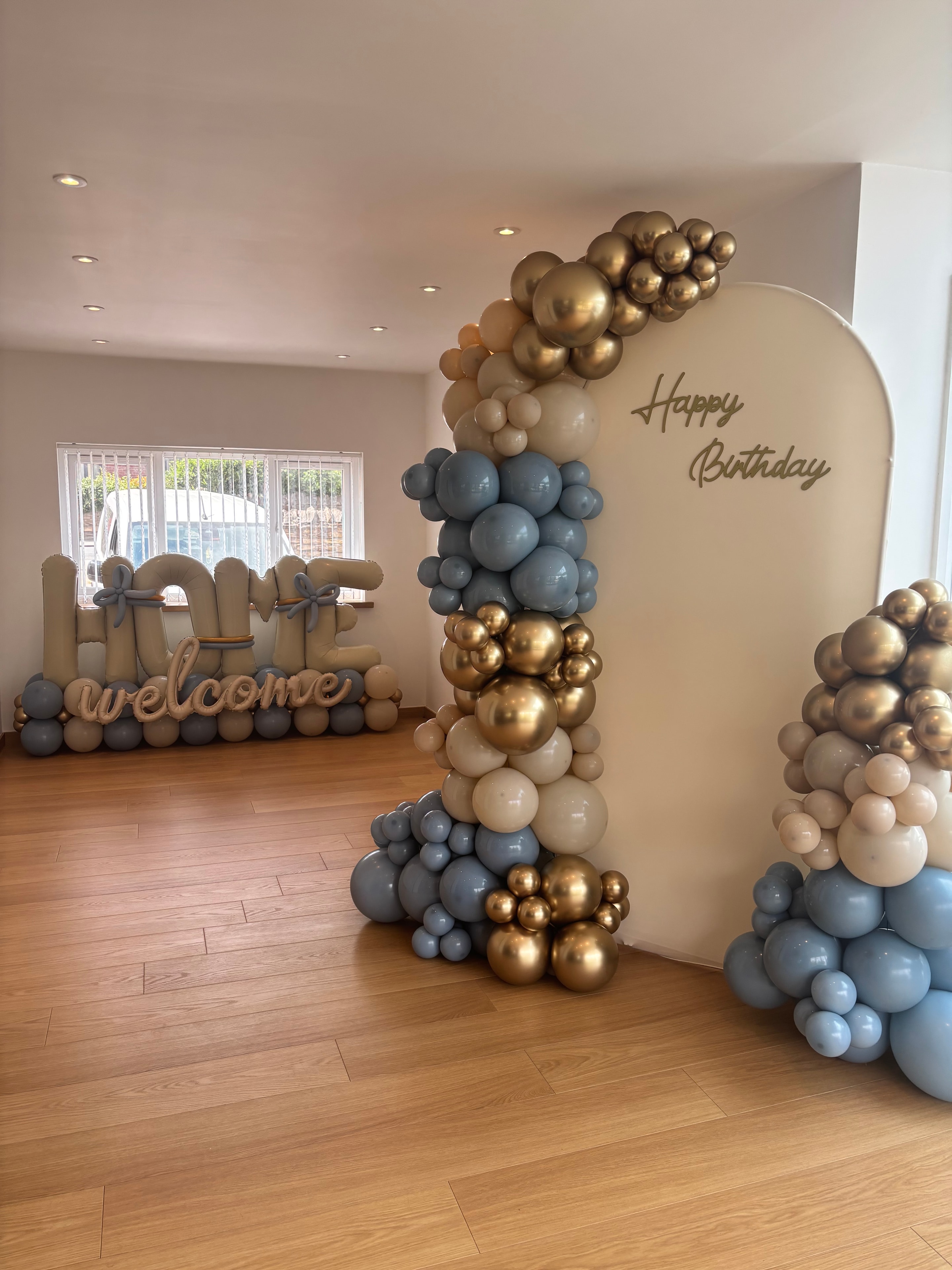 Balloon arch outside a brick building