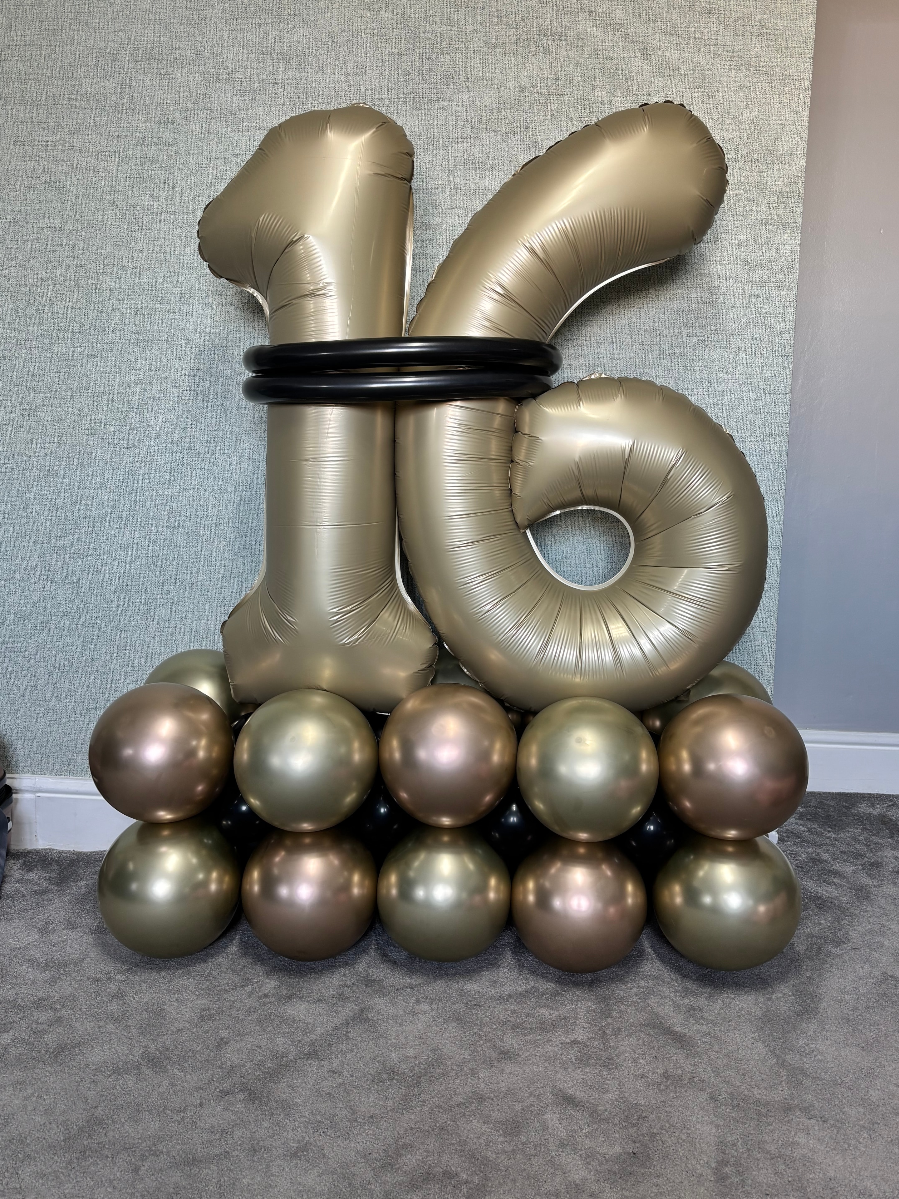 Gold and black number balloon display with chrome sphere cluster