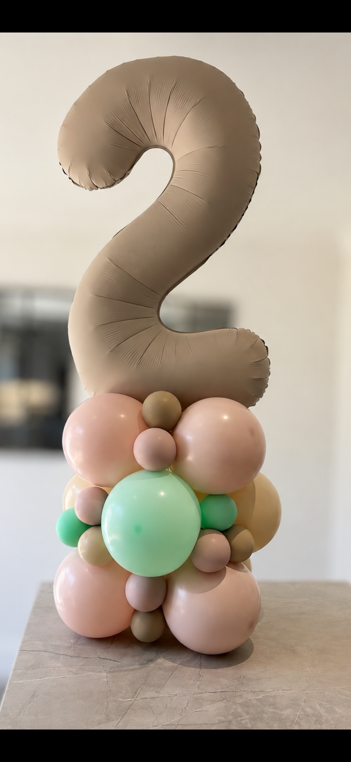 Number balloon sculpture with stacked spheres