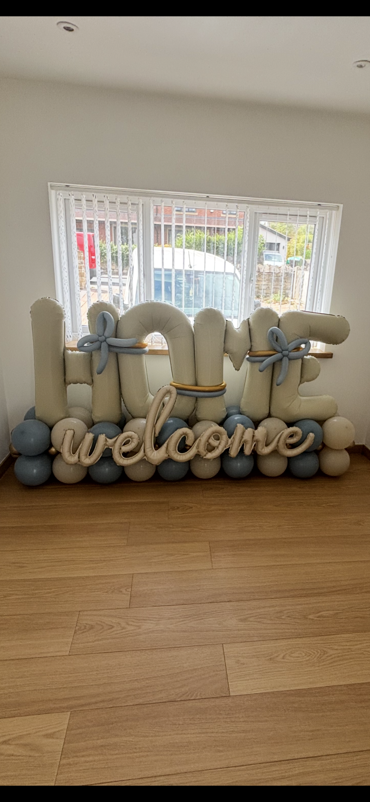 Balloon letter installation in cream and slate blue
